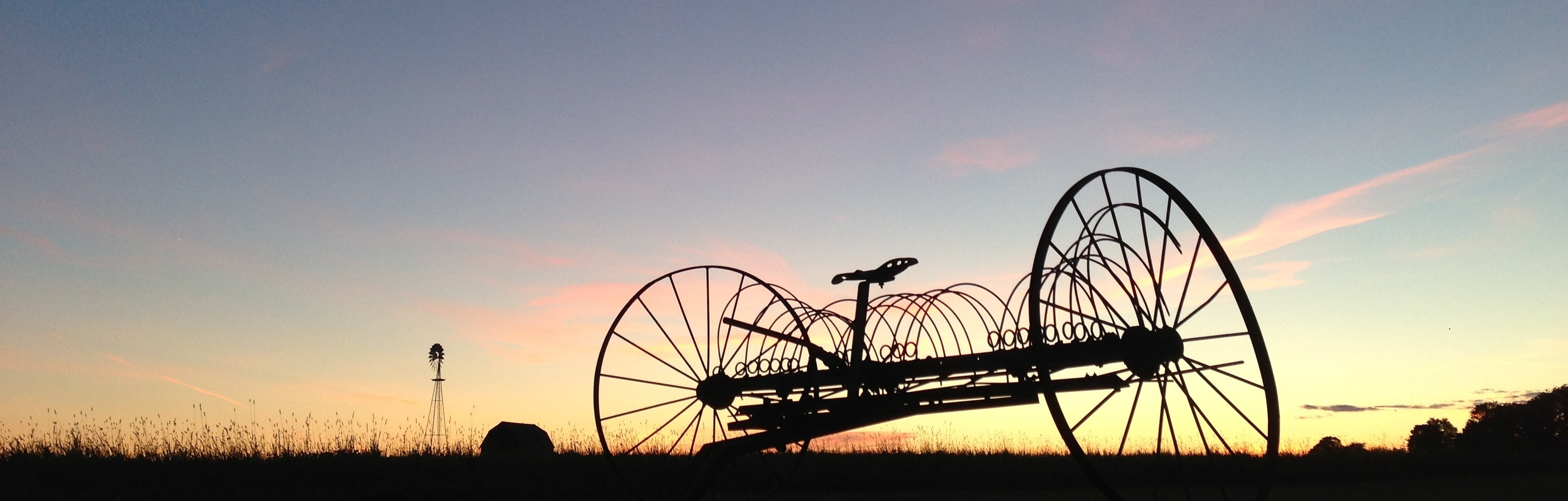 Hay rake and windmill on our grandmother’s farm in Caribou